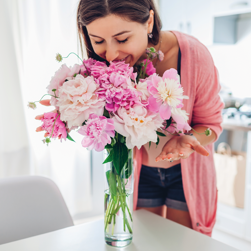 woman-smelling-flowers-800x800.png