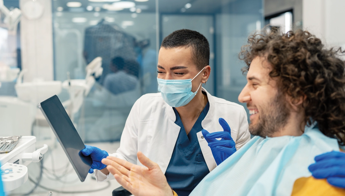 dentist-and-patient-looking-at-tablet-1200x683.webp