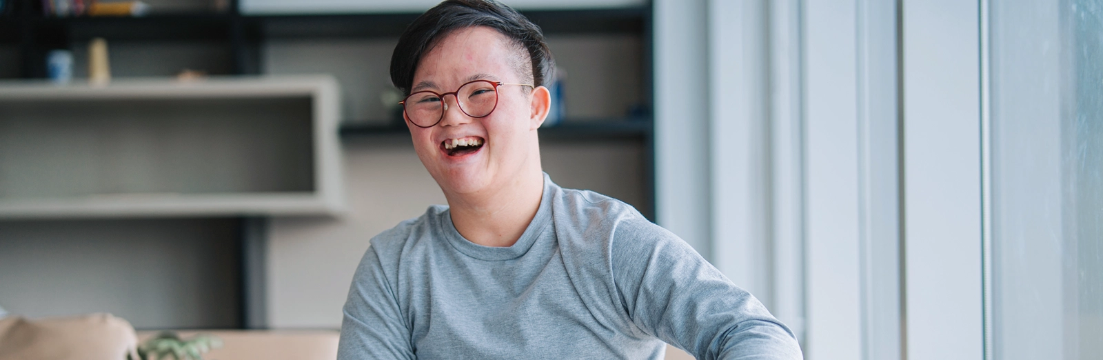 man-with-glasses-laughing2-1600x522-2.webp