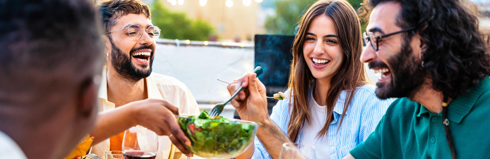 group-of-friends-enjoying-a-meal-together-1600x522.webp