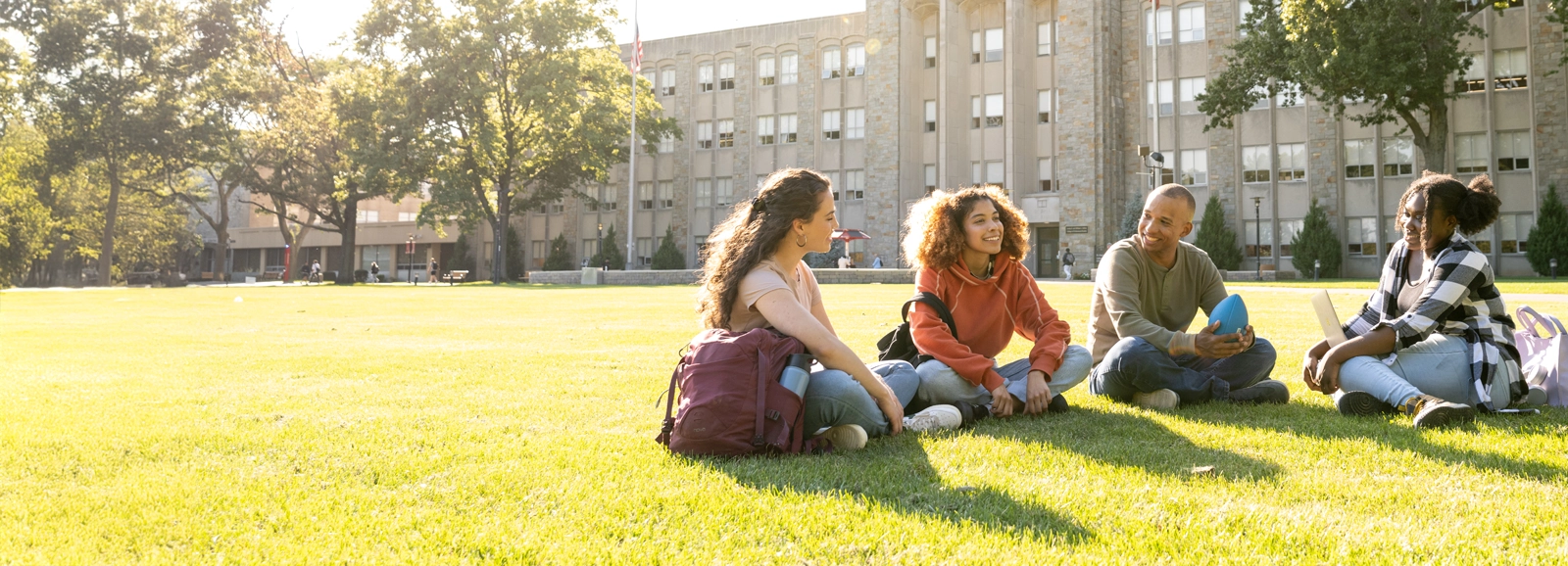 students-sitting-in-grass-outside-1600x578_1.webp