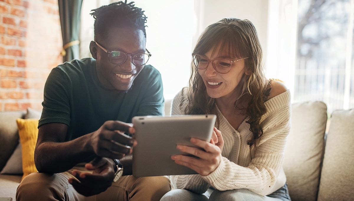 couple-looking-at-tablet-1200x683.webp