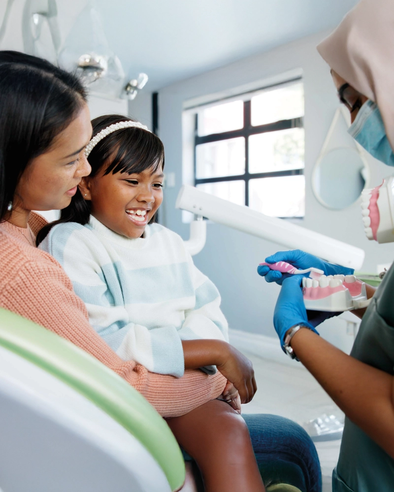 mother-and-daughter-talking-with-dentist-800x1000.webp