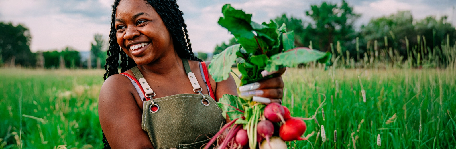 woman-smiling-holding-beets-1600x522.webp