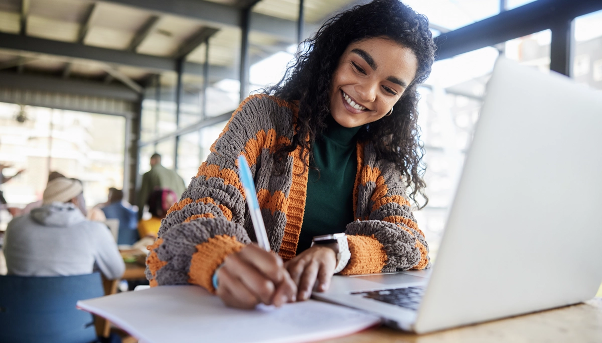 young-girl-smiling-while-writing-1200x683.webp