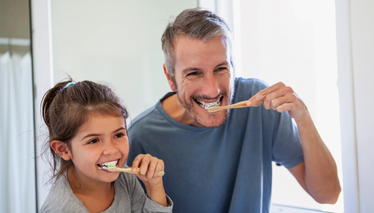 father-and-daughter-brushing-teeth-1200x683.webp