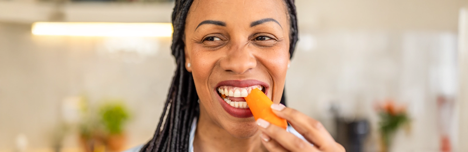 woman-eating-a-carrot-1600x522.webp