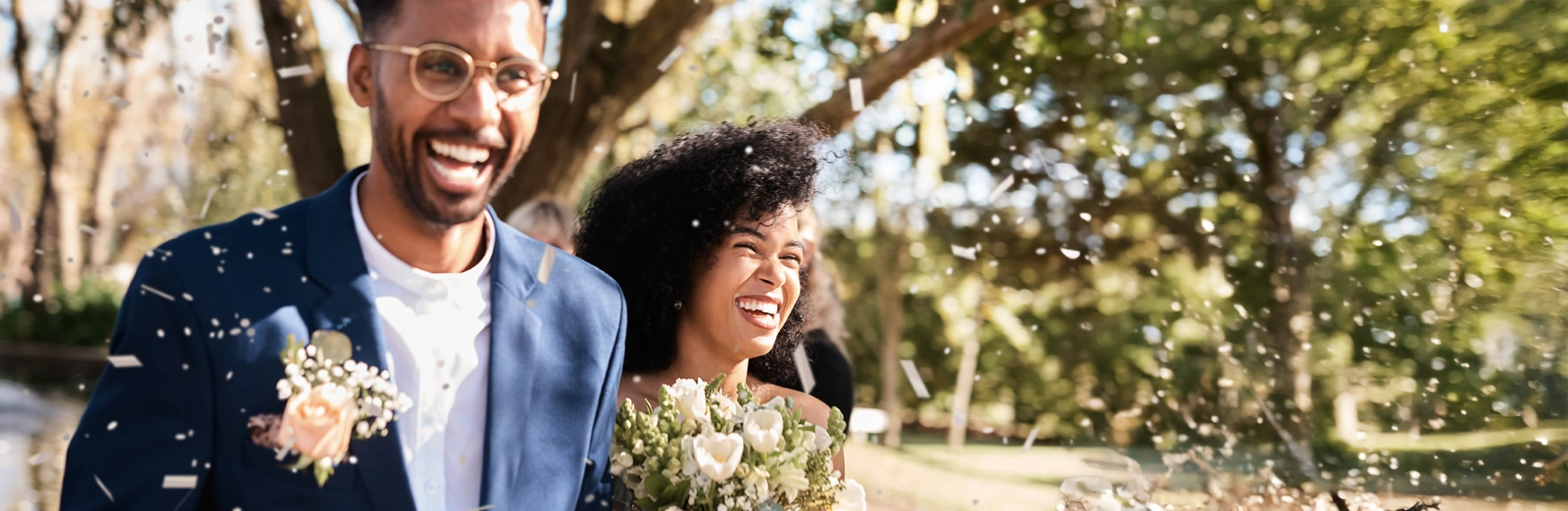 bride-and-groom-smiling-outside-1600x522.webp