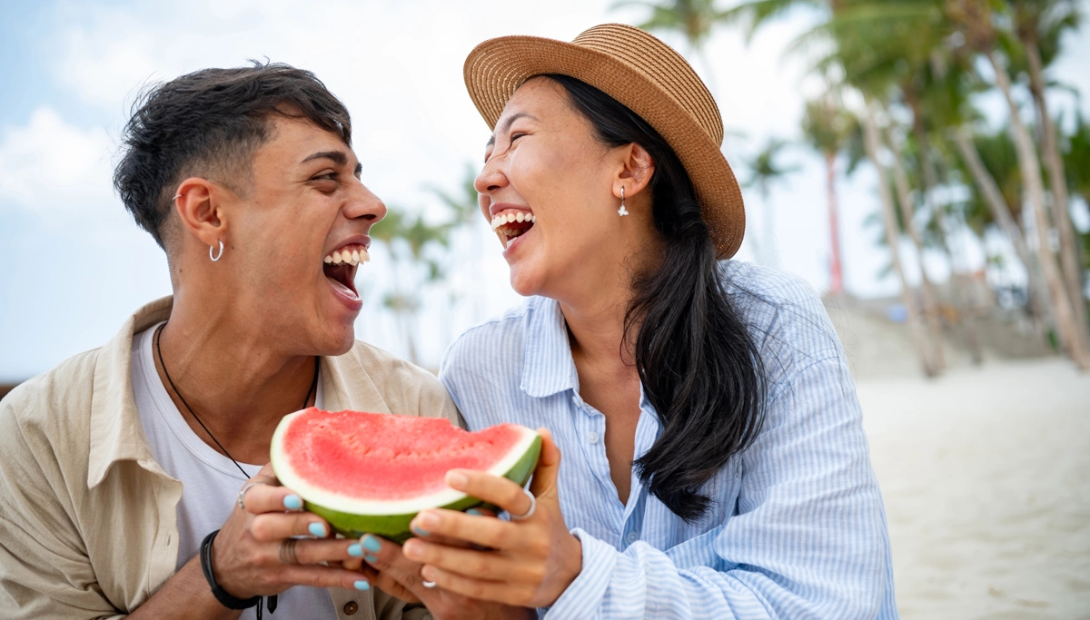couple-smiling-while-eating-watermelon-1200x683.webp