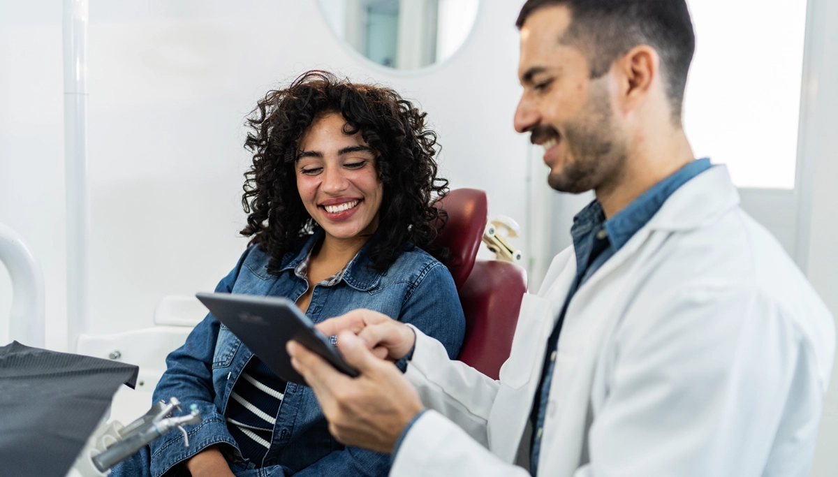 dentist-showing-a-patient-a-tablet-1200x683.webp
