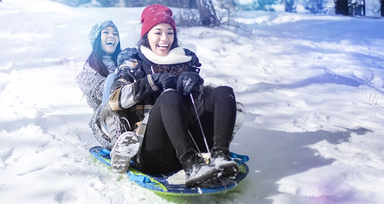 two-women-sledding-752x400.webp